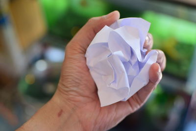 Close-up of hand holding crumpled paper
