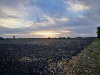 Scenic view of field against sky during sunset