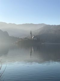 Scenic view of lake and mountains against sky