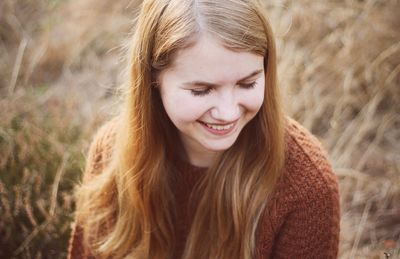 Smiling young woman on field