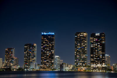Illuminated buildings in city at night