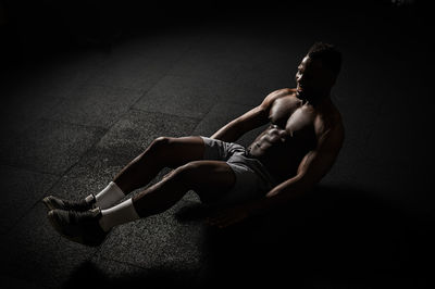 Full length of man exercising on floor