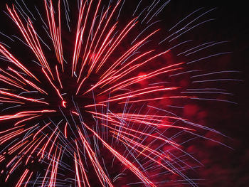 Low angle view of firework display at night