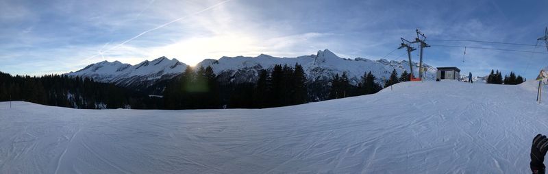 Scenic view of snow covered mountains against sky