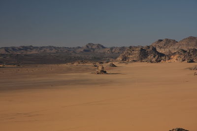Scenic view of desert against clear sky acacus mountain, libya