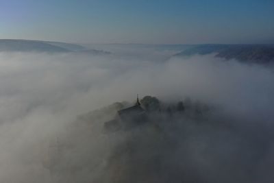 High angle view of mountain against cloudy sky