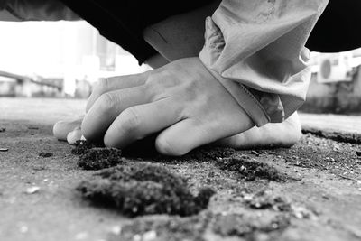 Man hand by leg on footpath