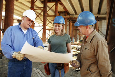 Group of construction workers looking over plans