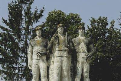 Low angle view of statue against trees