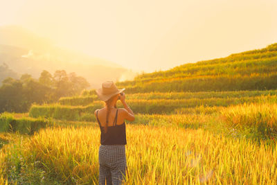  photograph asian woman taking photos with slr camera at rice terrace in sapa, vietnam