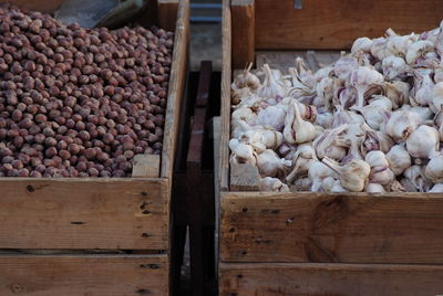 High angle view of garlic and chestnuts for sale at market stall