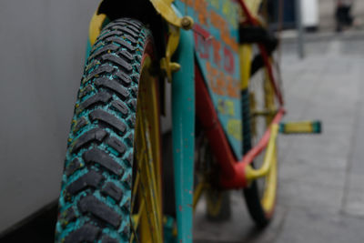 Close-up of multi colored bicycle against wall