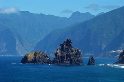 Panoramic view of sea and mountains against sky