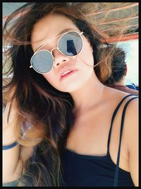 Portrait of young woman wearing sunglasses