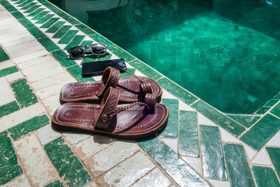 High angle view of old shoes on swimming pool