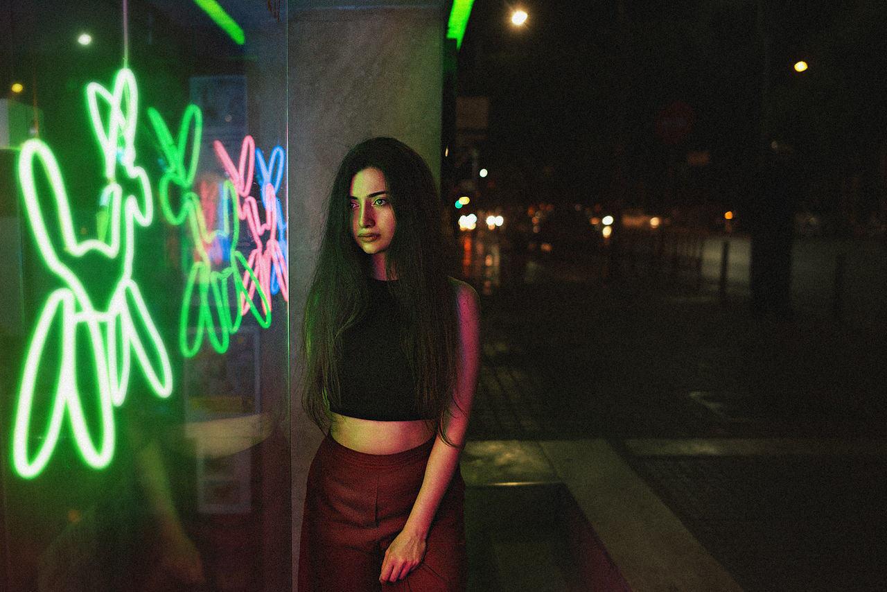 illuminated, night, real people, lifestyles, one person, young adult, outdoors, neon, city, people