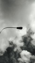 Low angle view of street light against cloudy sky