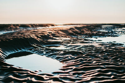 Scenic view of sea against clear sky during sunset