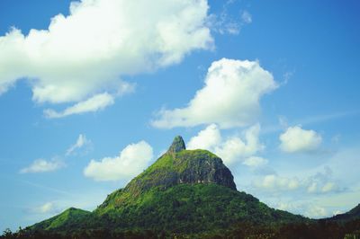 Low angle view of rock formations against blue sky