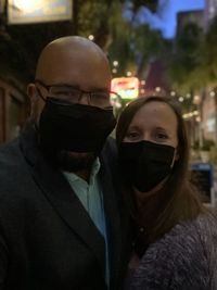 Portrait of man with woman wearing mask