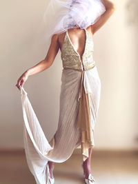 Un abito da sposa onirico realizzato con scampoli di seta. il velo sul viso è un omaggio a magritte 