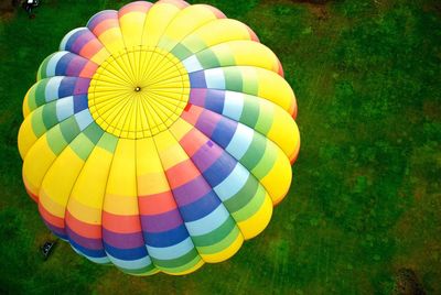 Hot air balloons flying over grass