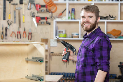 Portrait of smiling carpenter at workshop