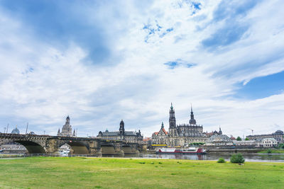 Church and bridge against cloudy sky