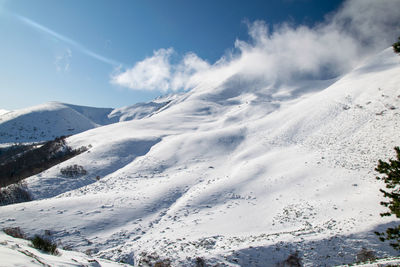Scenic view of snowcapped mountains against sky