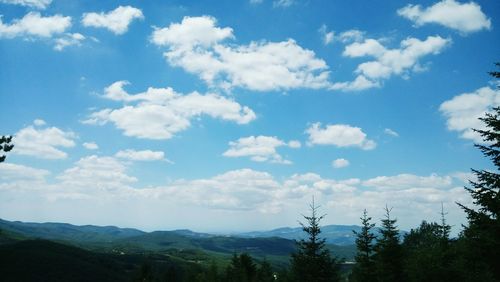 Scenic view of mountains against cloudy sky