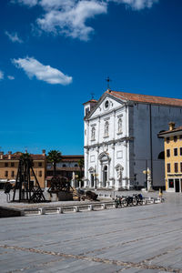 Buildings in city against blue sky