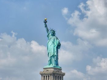 Low angle view of statue against cloudy sky