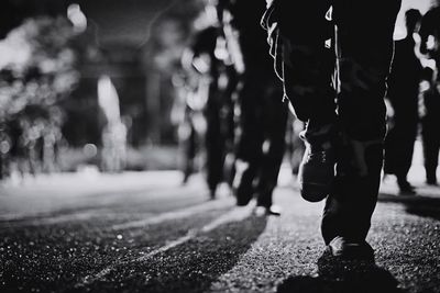 Low section of people walking on road