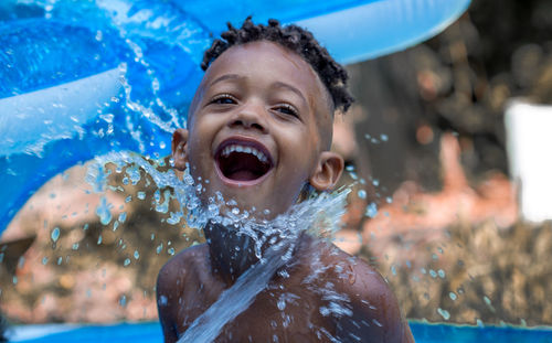 Portrait of smiling boy in swimming pool