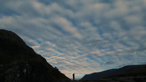 Silhouette of man against cloudy sky