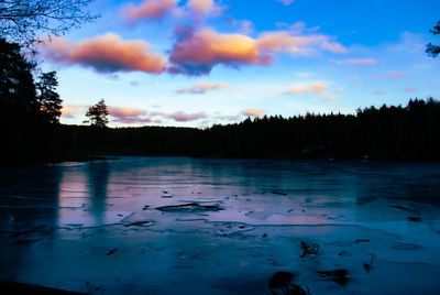 Scenic view of frozen lake against sky during sunset