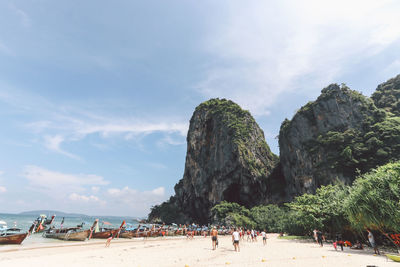 People at beach against sky