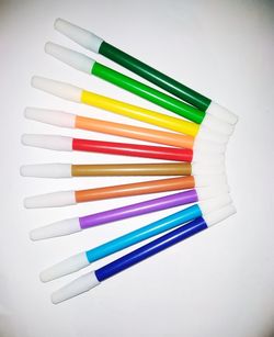 High angle view of colored pencils on white table