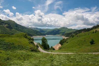 Scenic view of lake and mountains against sky