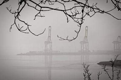 View of lake against sky during foggy weather