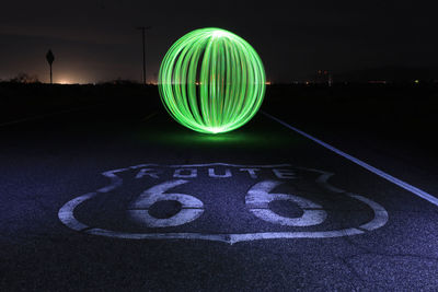 Light painting on field against sky at night