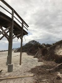 Built structure on beach against sky