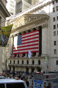 People on street against buildings in city