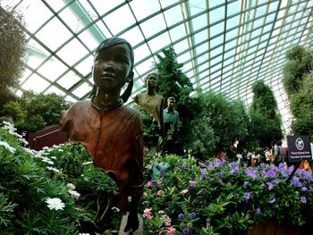 Statue of people on flowering plants
