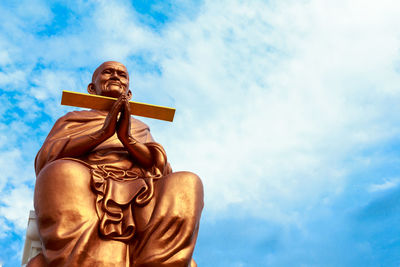 Low angle view of statue against sky