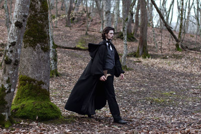 Man in period costume walking in forest