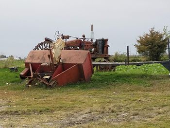 Abandoned truck on field against sky