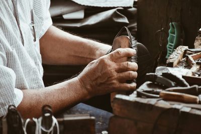 Midsection of man polishing shoes