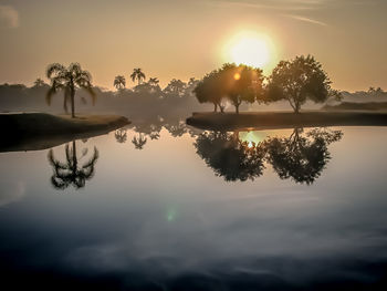 Scenic view of lake against sky during sunset
