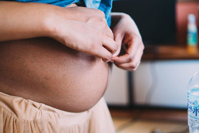 Midsection of women sitting at home